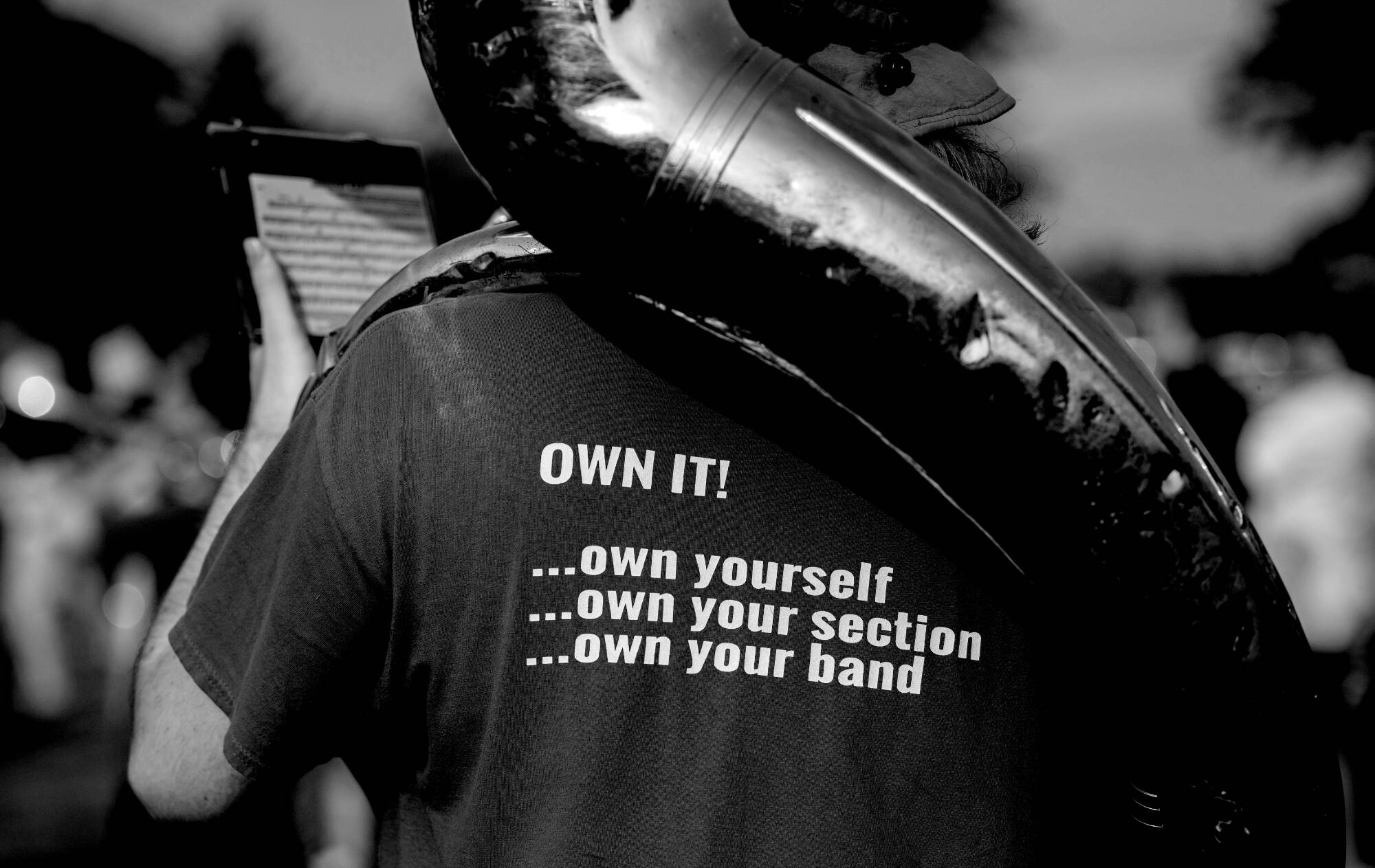 A T-shirt with an inspirational message is worn by a sousaphone player.